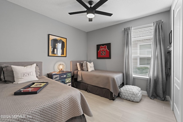 bedroom with baseboards and ceiling fan