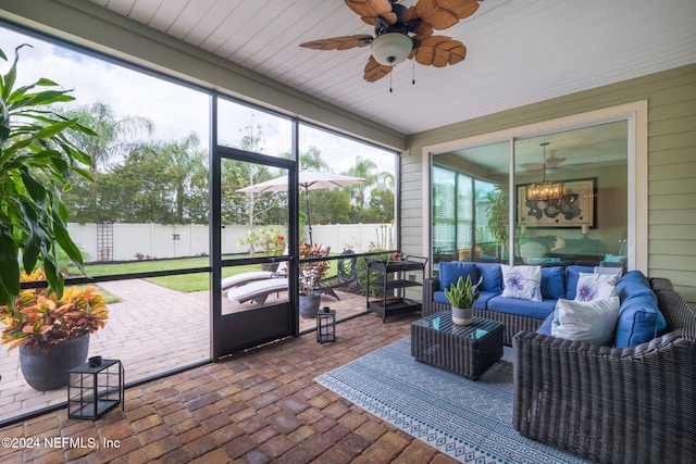sunroom featuring plenty of natural light, ceiling fan, and an outdoor hangout area