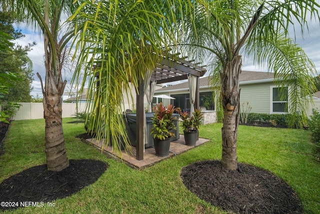 view of yard with a pergola, a hot tub, and fence