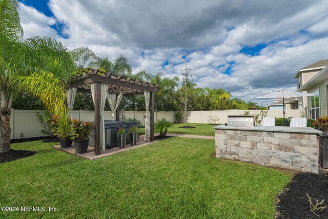 view of yard with a pergola, a patio area, a fenced backyard, a hot tub, and area for grilling
