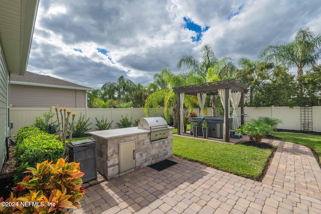view of patio with a fenced backyard, a grill, a pergola, an outdoor kitchen, and a hot tub