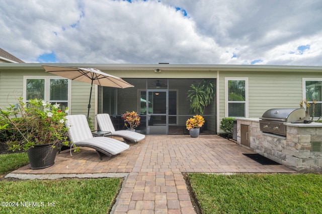 back of house featuring a patio area, a sunroom, area for grilling, and ceiling fan