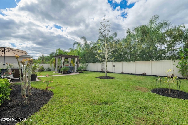 view of yard with a fenced backyard and a gazebo