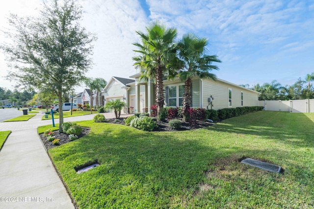 view of home's exterior featuring a gate, fence, a yard, and driveway
