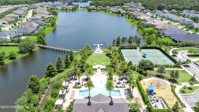 drone / aerial view featuring a residential view and a water view