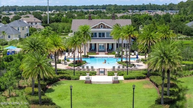 pool with a yard, a patio area, and fence
