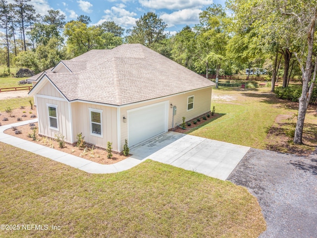6388 Miltondale Rd, Macclenny, FL 32063 - view of side of property with an attached garage, driveway, a shingled roof, and a lawn