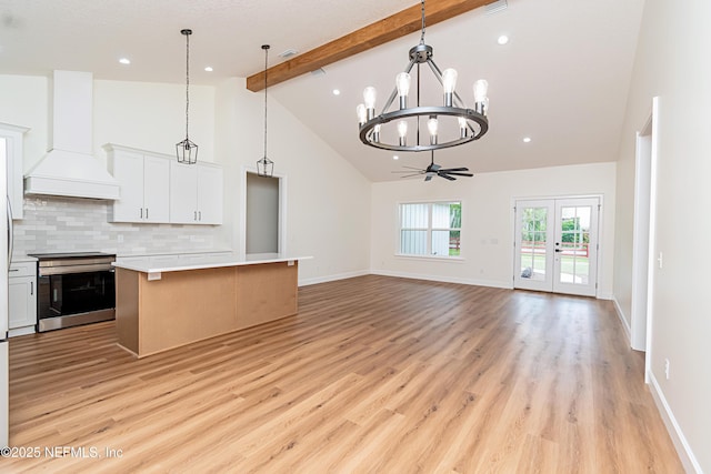 6388 Miltondale Rd, Macclenny, FL 32063 - kitchen with light countertops, a kitchen island, stainless steel electric range, light wood-style flooring, and custom exhaust hood