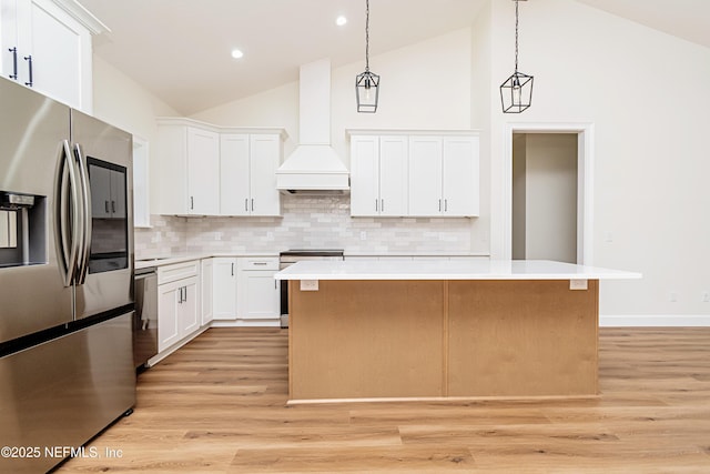 6388 Miltondale Rd, Macclenny, FL 32063 - kitchen with custom exhaust hood, light countertops, a center island, appliances with stainless steel finishes, and high vaulted ceiling
