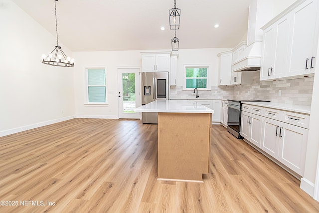 6388 Miltondale Rd, Macclenny, FL 32063 - kitchen featuring a center island, a sink, decorative backsplash, light countertops, and appliances with stainless steel finishes