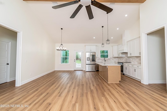 6388 Miltondale Rd, Macclenny, FL 32063 - kitchen with high vaulted ceiling, custom exhaust hood, a ceiling fan, light countertops, and appliances with stainless steel finishes