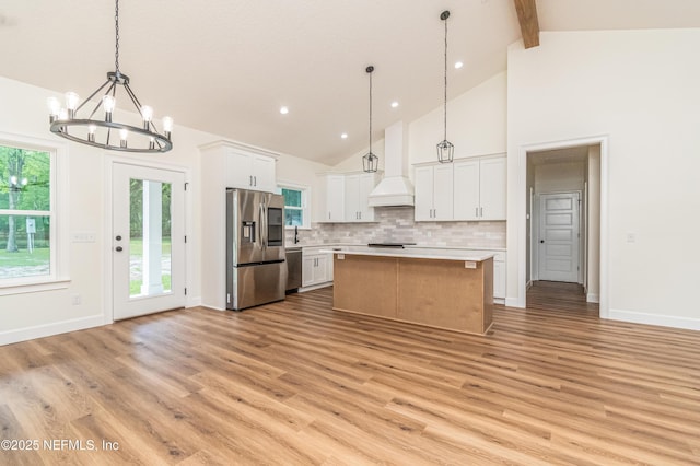 6388 Miltondale Rd, Macclenny, FL 32063 - kitchen featuring tasteful backsplash, a chandelier, custom range hood, stainless steel refrigerator with ice dispenser, and light countertops