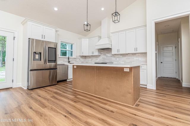 6388 Miltondale Rd, Macclenny, FL 32063 - kitchen with premium range hood, light countertops, light wood-type flooring, and appliances with stainless steel finishes