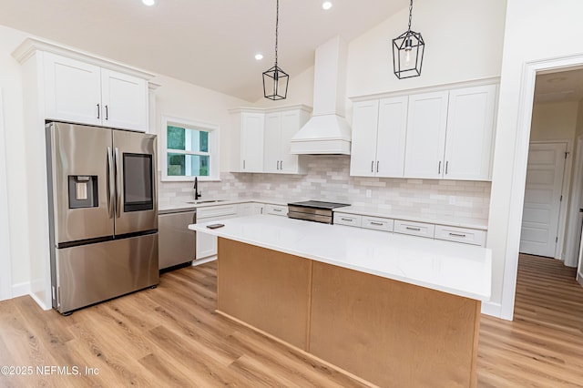 6388 Miltondale Rd, Macclenny, FL 32063 - kitchen with custom exhaust hood, tasteful backsplash, a sink, light countertops, and appliances with stainless steel finishes