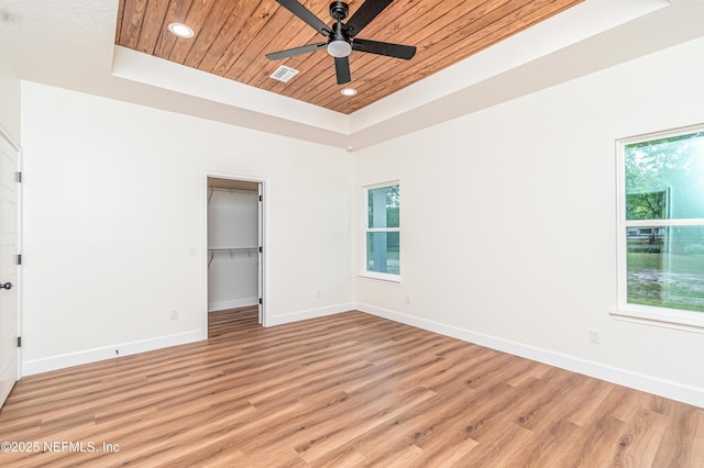 6388 Miltondale Rd, Macclenny, FL 32063 - unfurnished bedroom featuring wood ceiling, light wood finished floors, a raised ceiling, and multiple windows