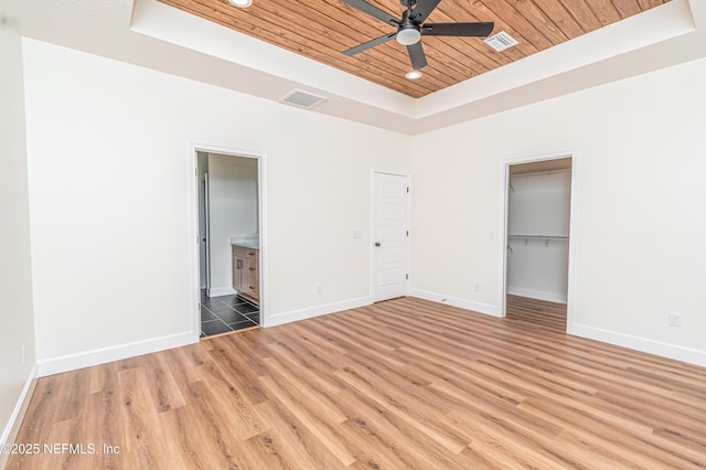 6388 Miltondale Rd, Macclenny, FL 32063 - unfurnished bedroom with light wood-style floors, a tray ceiling, wooden ceiling, baseboards, and visible vents