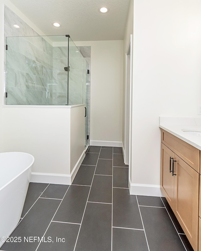 6388 Miltondale Rd, Macclenny, FL 32063 - bathroom with vanity, tile patterned flooring, a freestanding bath, and a stall shower