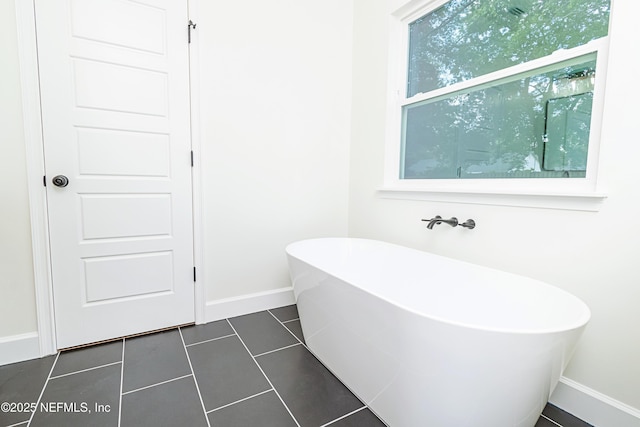 6388 Miltondale Rd, Macclenny, FL 32063 - bathroom with baseboards, tile patterned flooring, and a freestanding bath