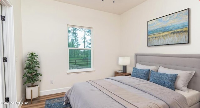 6388 Miltondale Rd, Macclenny, FL 32063 - bedroom with baseboards and wood finished floors