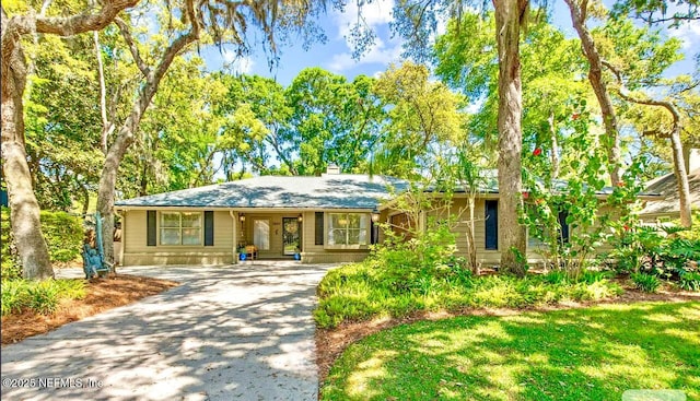 1937 Lakeside Dr N, Fernandina Beach, FL 32034 - ranch-style home featuring concrete driveway and a chimney