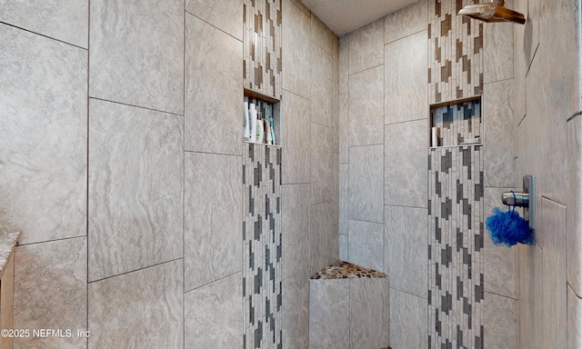 interior details featuring tiled shower