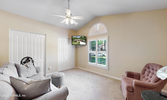 living area featuring light colored carpet, baseboards, ceiling fan, and lofted ceiling
