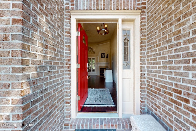 doorway to property with brick siding