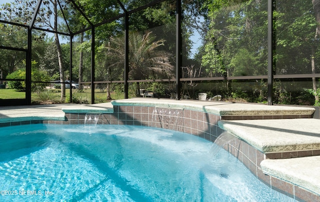 outdoor pool featuring a hot tub and a lanai