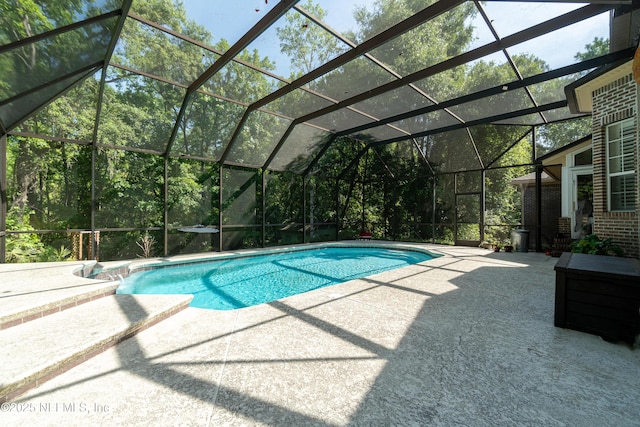 outdoor pool with a patio and a lanai