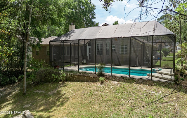 pool with glass enclosure and a yard