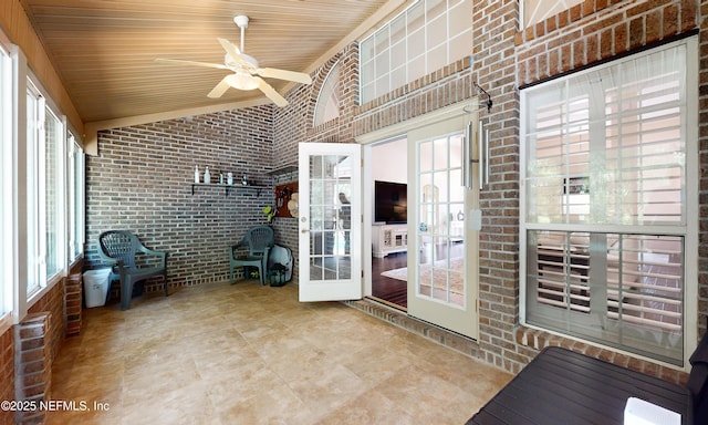 unfurnished sunroom with ceiling fan