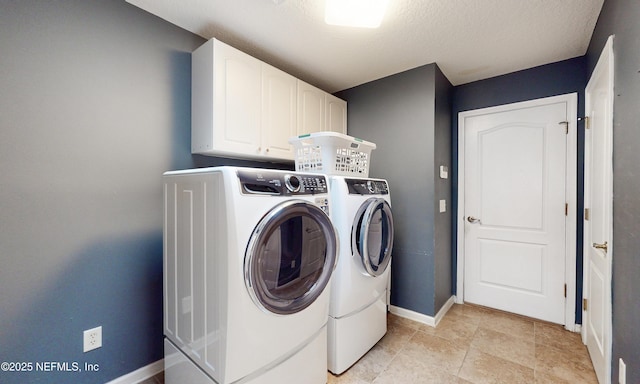 laundry room with baseboards, cabinet space, and washing machine and clothes dryer