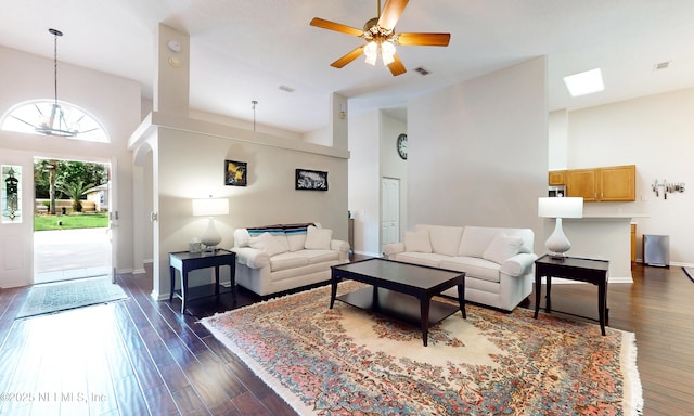living room with visible vents, dark wood-style flooring, and a high ceiling