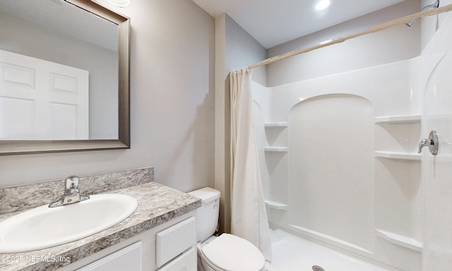 full bathroom featuring vanity, toilet, and a stall shower