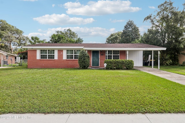 5635 Hillman Dr, Jacksonville, FL 32244 - ranch-style house with a carport, a front lawn, and driveway