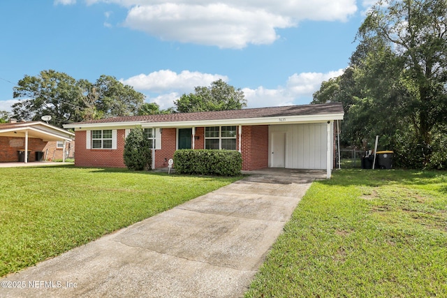 5635 Hillman Dr, Jacksonville, FL 32244 - ranch-style house with brick siding, driveway, a front yard, and a carport