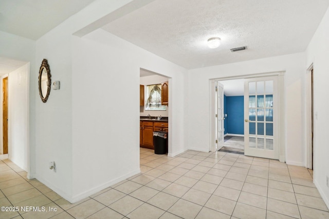 5635 Hillman Dr, Jacksonville, FL 32244 - unfurnished room with visible vents, a sink, a textured ceiling, and light tile patterned floors
