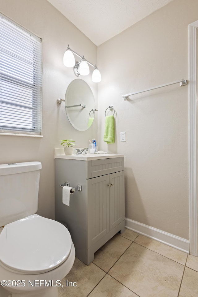 4532 Jade Dr E, Jacksonville, FL 32210 - bathroom with toilet, vanity, tile patterned floors, and baseboards