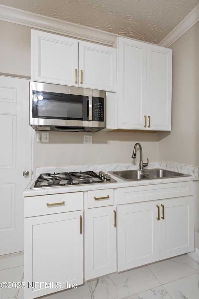 4532 Jade Dr E, Jacksonville, FL 32210 - kitchen featuring marble finish floor, appliances with stainless steel finishes, a sink, and white cabinets