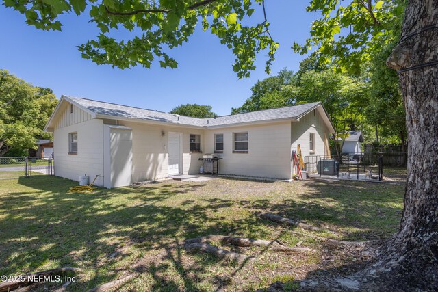 4532 Jade Dr E, Jacksonville, FL 32210 - rear view of house featuring a gate, a yard, and a fenced backyard