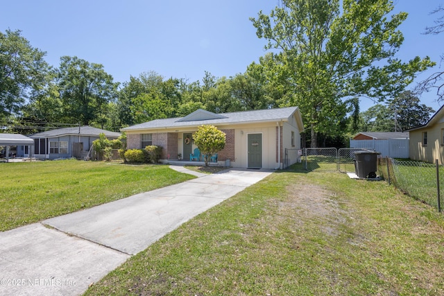 4532 Jade Dr E, Jacksonville, FL 32210 - view of front of property with a gate, driveway, fence, brick siding, and a front yard