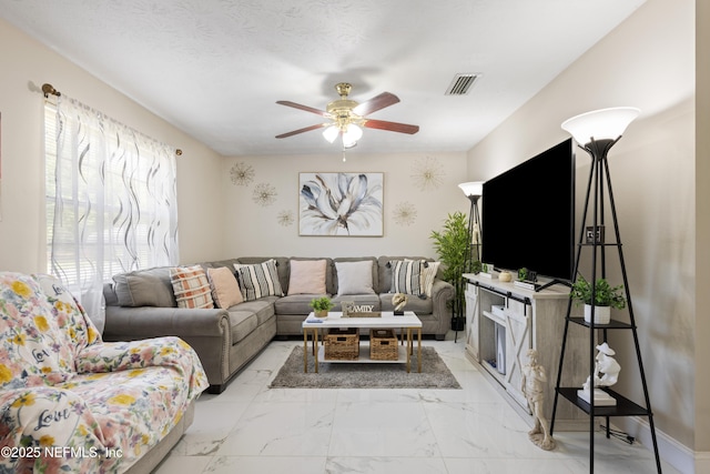 4532 Jade Dr E, Jacksonville, FL 32210 - living room with marble finish floor, visible vents, and a ceiling fan