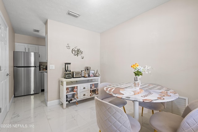 4532 Jade Dr E, Jacksonville, FL 32210 - dining space featuring marble finish floor, baseboards, and visible vents