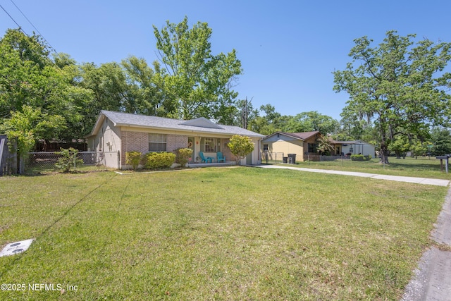 4532 Jade Dr E, Jacksonville, FL 32210 - ranch-style home featuring brick siding, a front yard, and fence