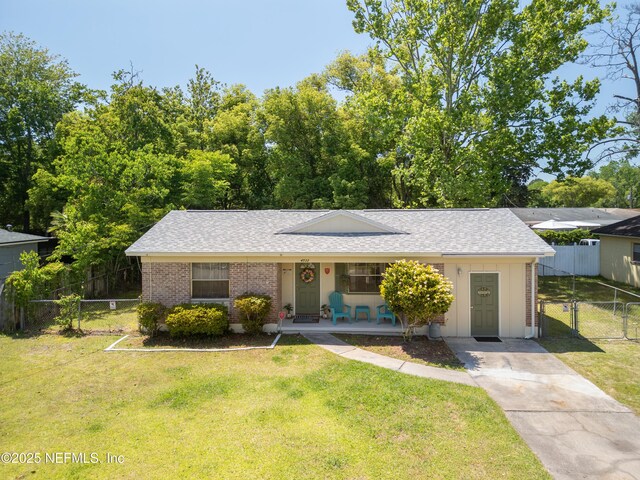 4532 Jade Dr E, Jacksonville, FL 32210 - view of front of house with brick siding, a front yard, and covered porch