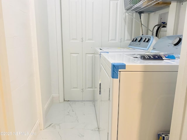 4532 Jade Dr E, Jacksonville, FL 32210 - clothes washing area with baseboards, marble finish floor, laundry area, and separate washer and dryer