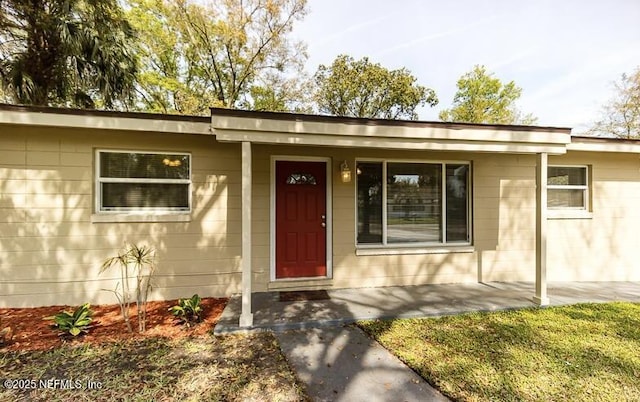 8855 Yeoman Dr, Jacksonville, FL 32208 - doorway to property with a porch and concrete block siding