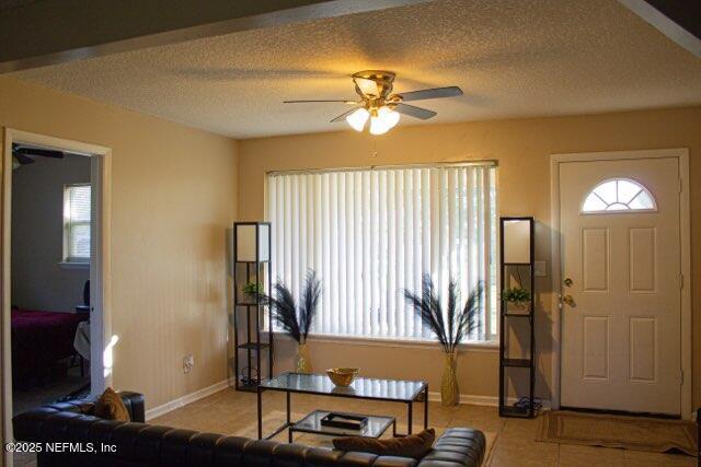 8855 Yeoman Dr, Jacksonville, FL 32208 - living area featuring baseboards, a ceiling fan, and a textured ceiling