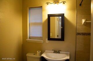 8855 Yeoman Dr, Jacksonville, FL 32208 - bathroom featuring vanity, toilet, and a shower