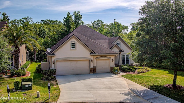 1911 Salt Creek Dr, Fleming Island, FL 32003 - traditional home with a front lawn, driveway, stone siding, an attached garage, and stucco siding